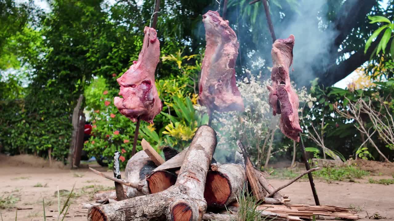 Traditional Venezuelan Llanos Meat Cooking on Sticks over Open Fire