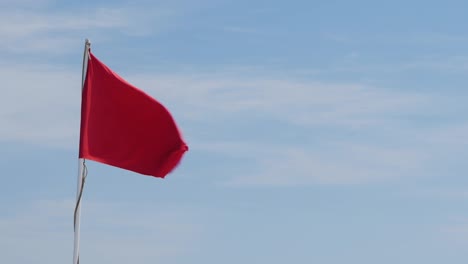 red flag on a background of blue sky