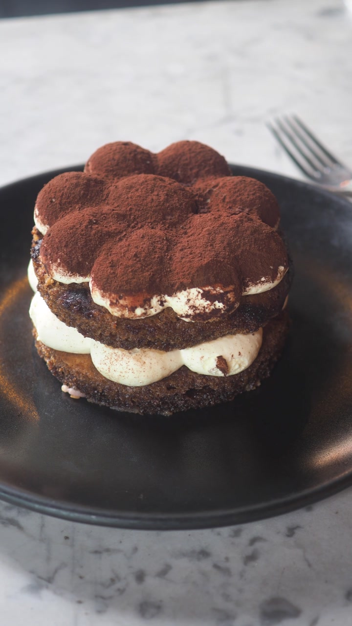 Gourmet Tiramisu Dessert Served on a Black Plate
