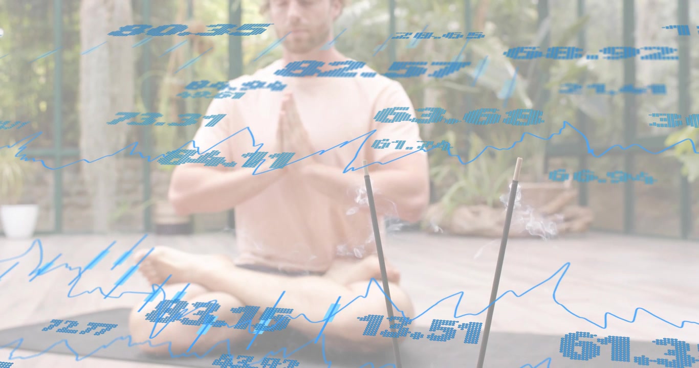Mann løfter håndflatene til bønne-/meditasjonsstilling på yogamatte, aktiverer flytende grafer som overvåker velvære