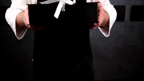 person holding a black gift box