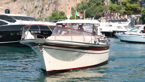 boats maneuvering in sorrento's busy harbor