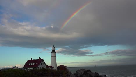 remarkable shot of the portland head lighthouse in maine with full rainbow above