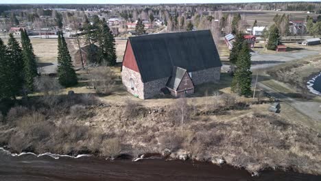 Old-finnish-stone-churh-going-in-with-drone