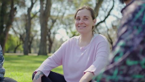 women relaxing and discussing in a park
