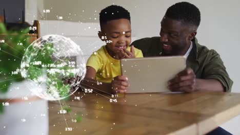 animation of globe with numbers over happy african american father and son using tablet