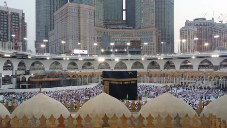 muslim pilgrims circumambulating and pray facing the kaaba