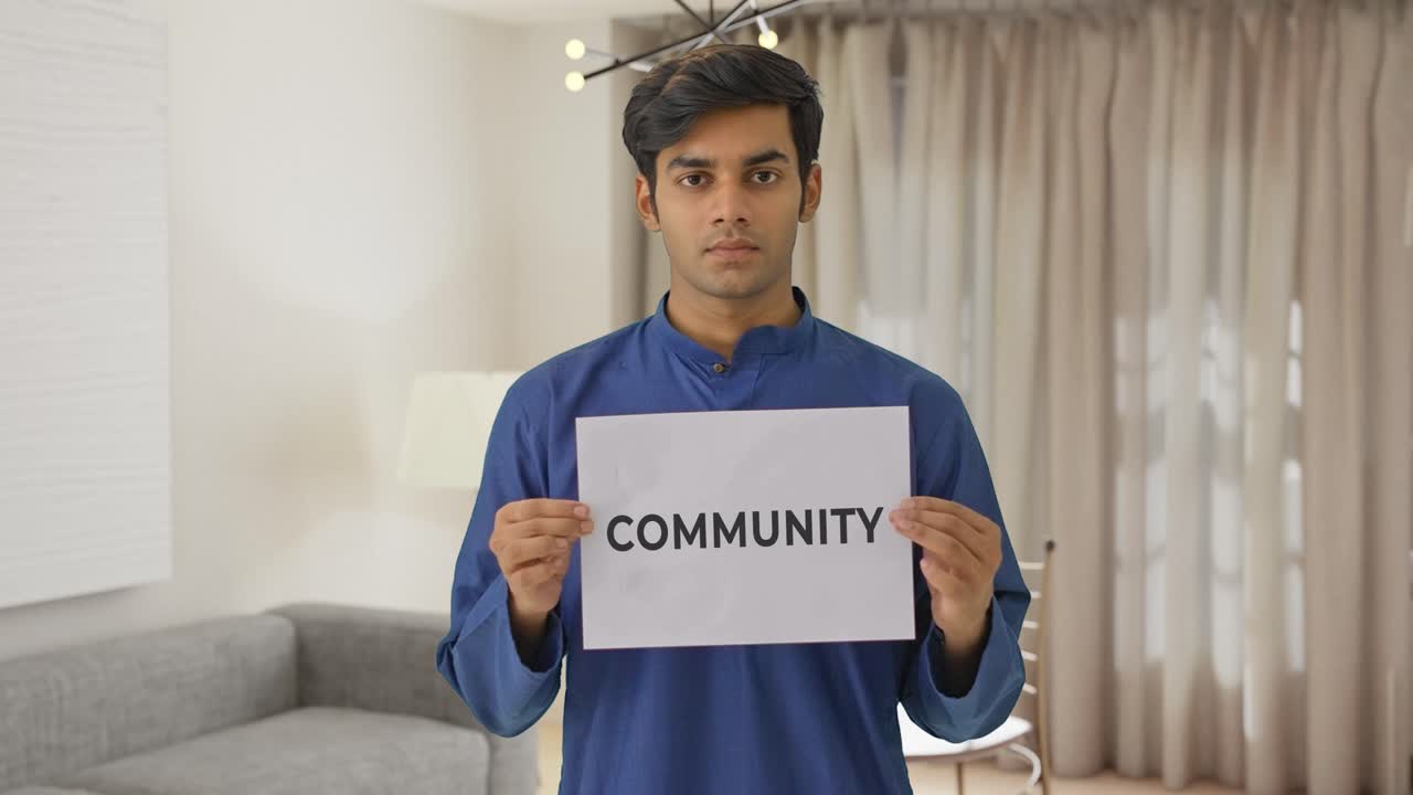 Indian boy holding COMMUNITY banner