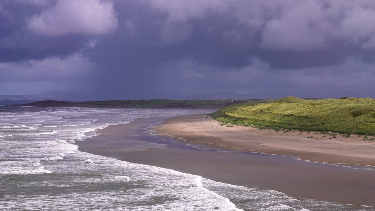 Wide view of Waves and Hilly Grass along the Shore at Tullan Grand in Lietrim County Ireland