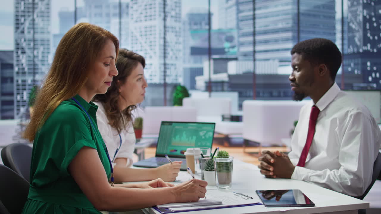 HR recruiters interviewing a job seeker and taking notes during meeting