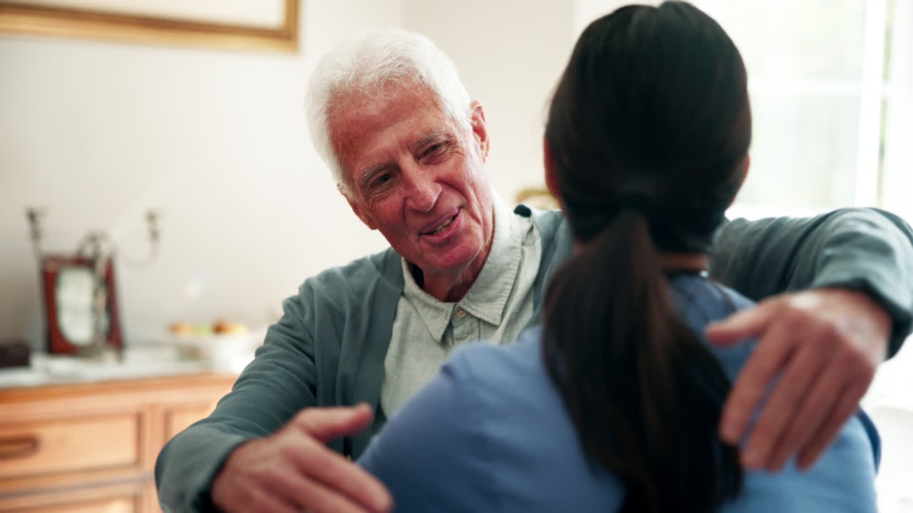 Elderly man hugging his caregiver