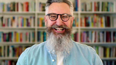 Senior-male-librarian-laughing-inside-a-library