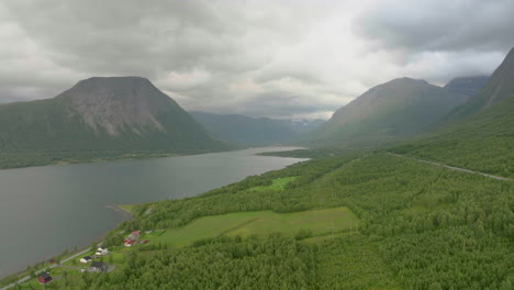 Aerial-over-forested-landscape-next-to-E6-Highway-toward-Nordkjosbotn,-Norway