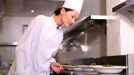 chef checking plates of dinner on counter