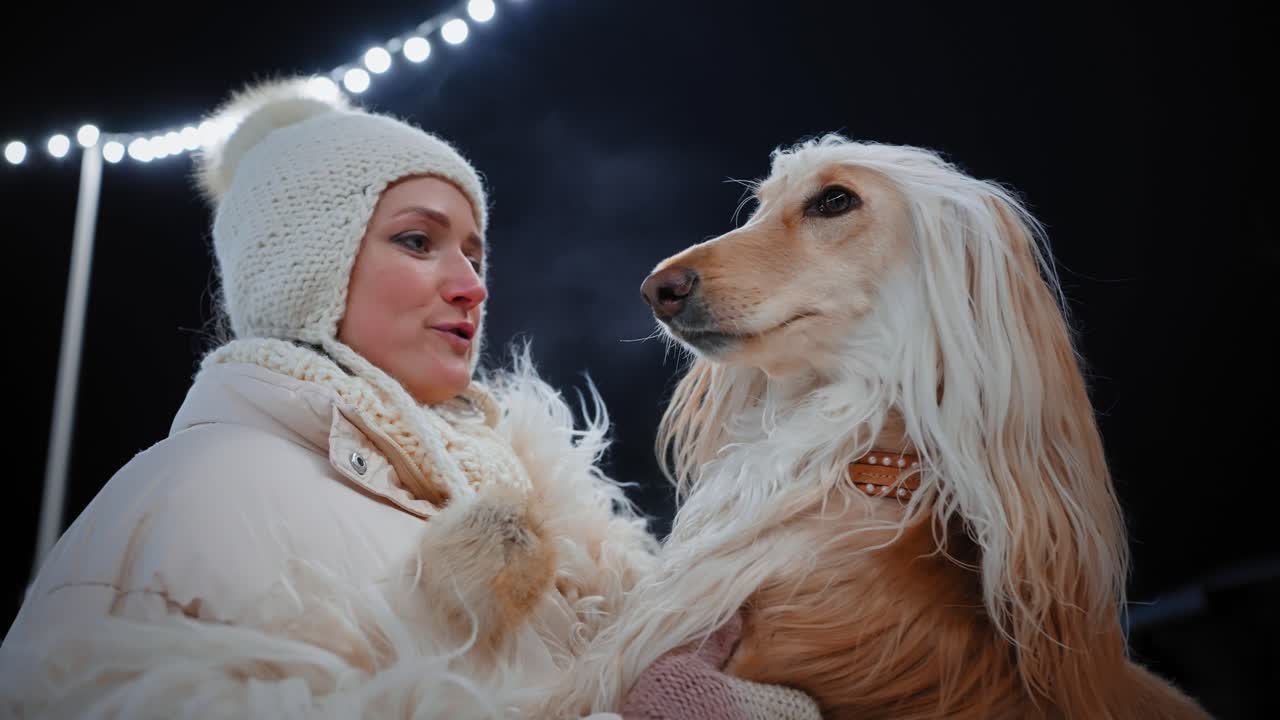 Woman and her dog at night