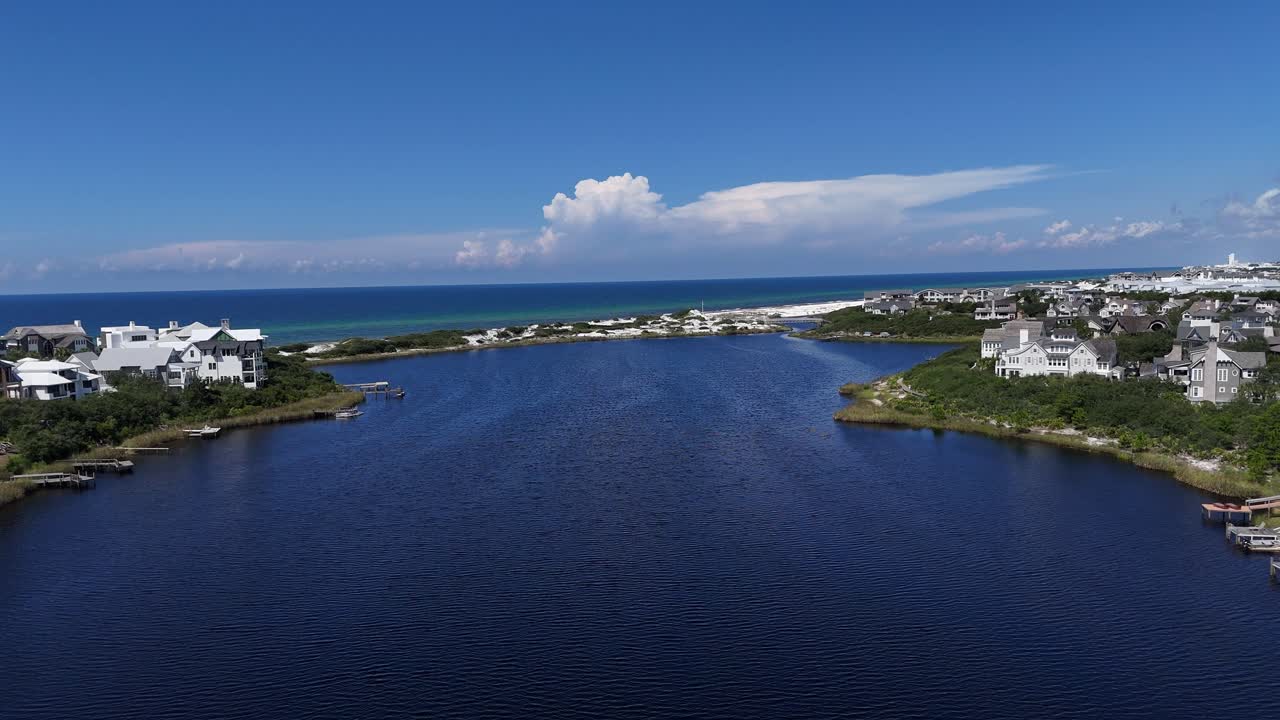 Dynamic drone fly over the beautiful calm Camp Creek Lake towards the Seacrest Beach, 30A, Florida, USA