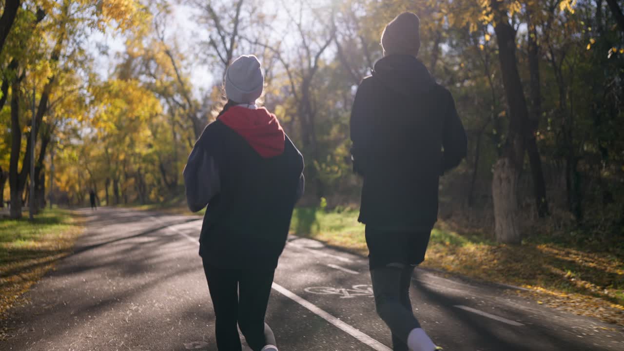 Um casal a correr no Parque de Outono