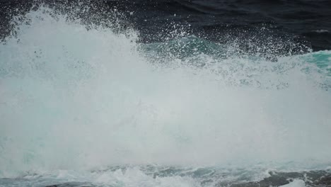 a massive turquoise wave crashes with force near the iconic atlantic road in norway, capturing raw ocean energy.