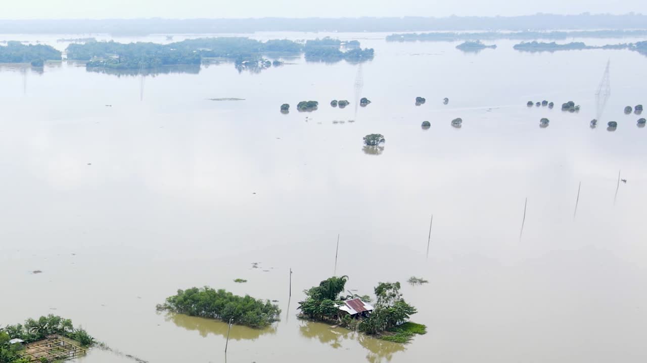 Vast haor wetland area submerged in flood water in Bangladesh. Flooded rural village homes seen from the top