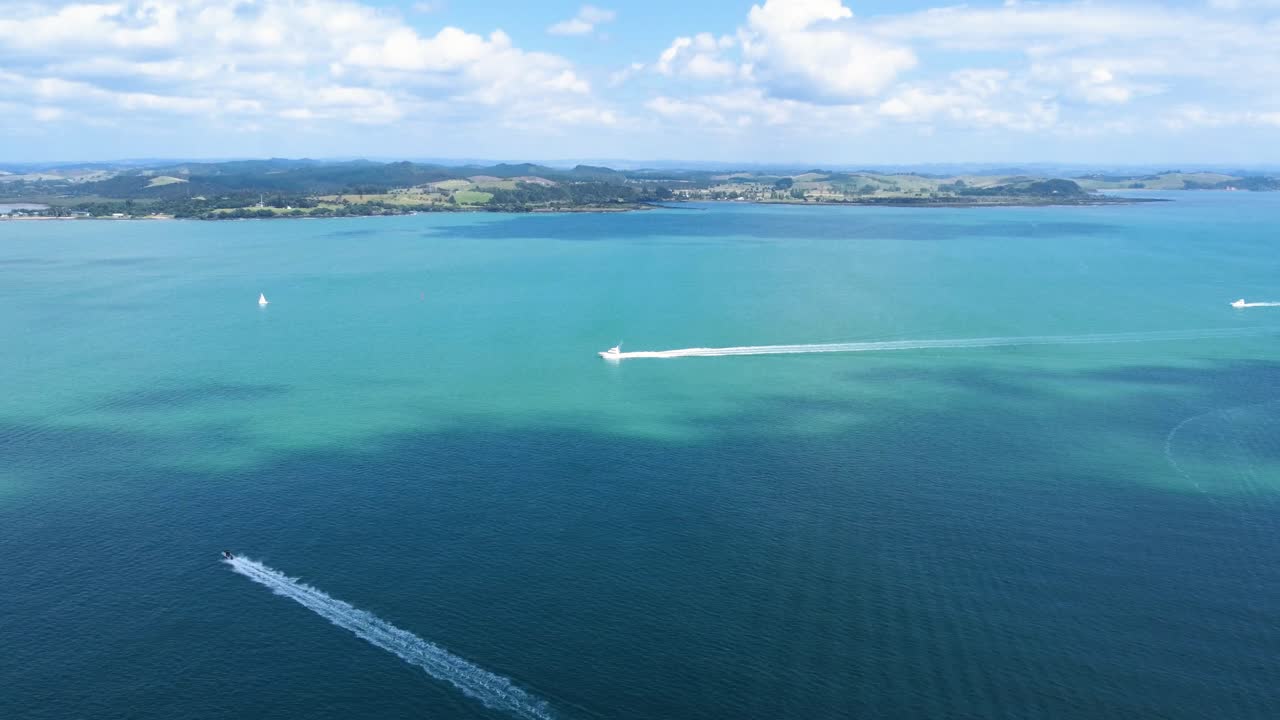 AERIAL Shot of Bay of Islands and Boats Cutting through it in New Zealand