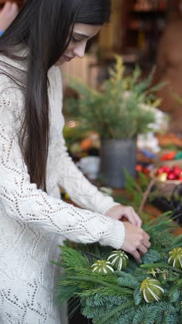 woman crafting a festive christmas wreath