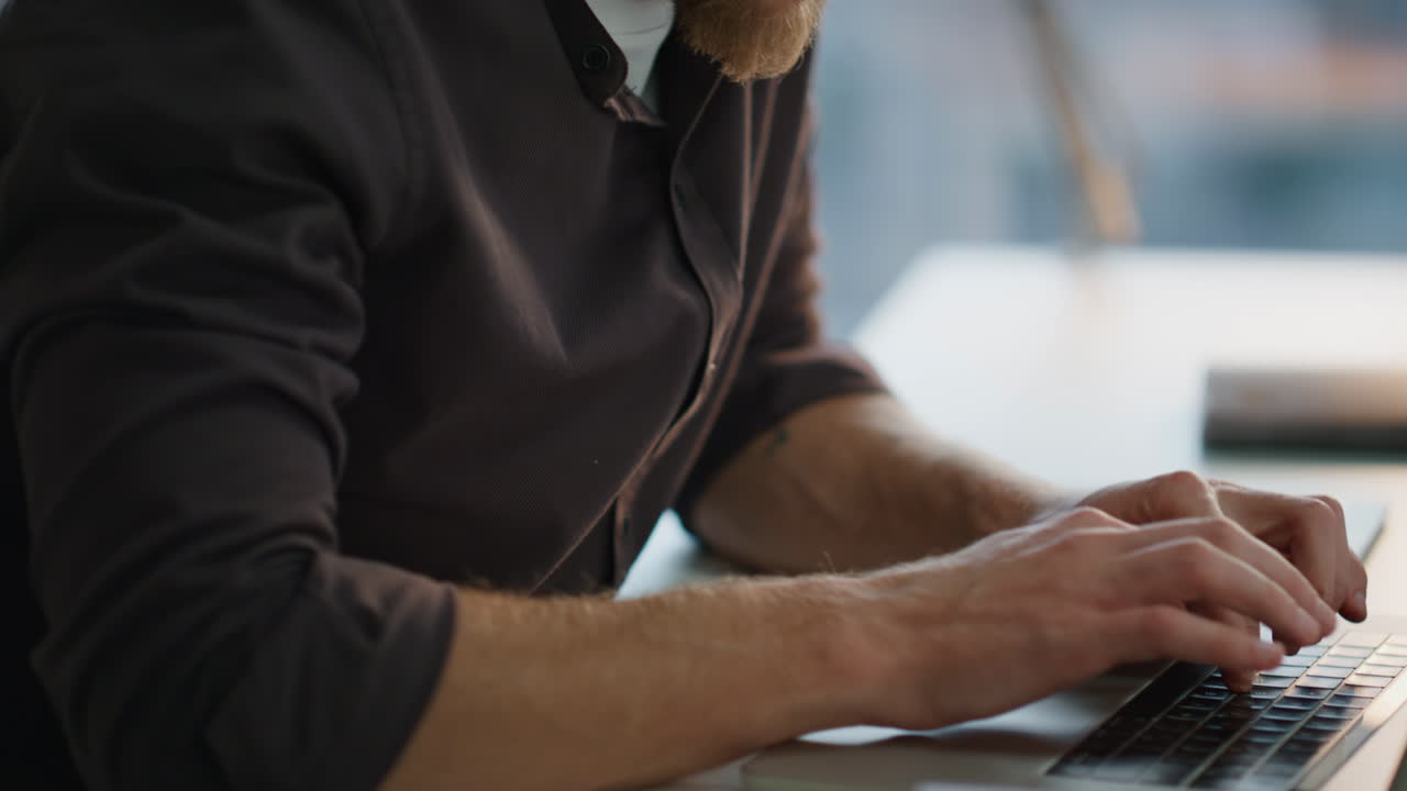 Serious man fingers texting keyboard office closeup. Freelancer working laptop