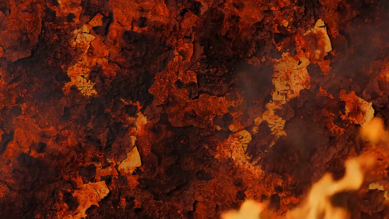 Emitting faint glow, charred surface growing small flames at bottom, drifting embers curling upward