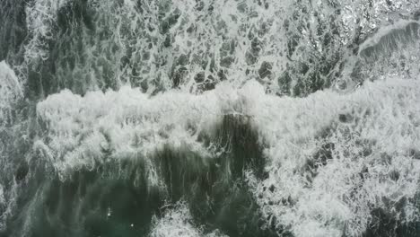 Close-up-drone-shot-of-blue-waves-crashing