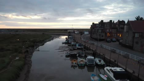 slow moving footage along river glaven at blakeney quay in norfolk at sunrise