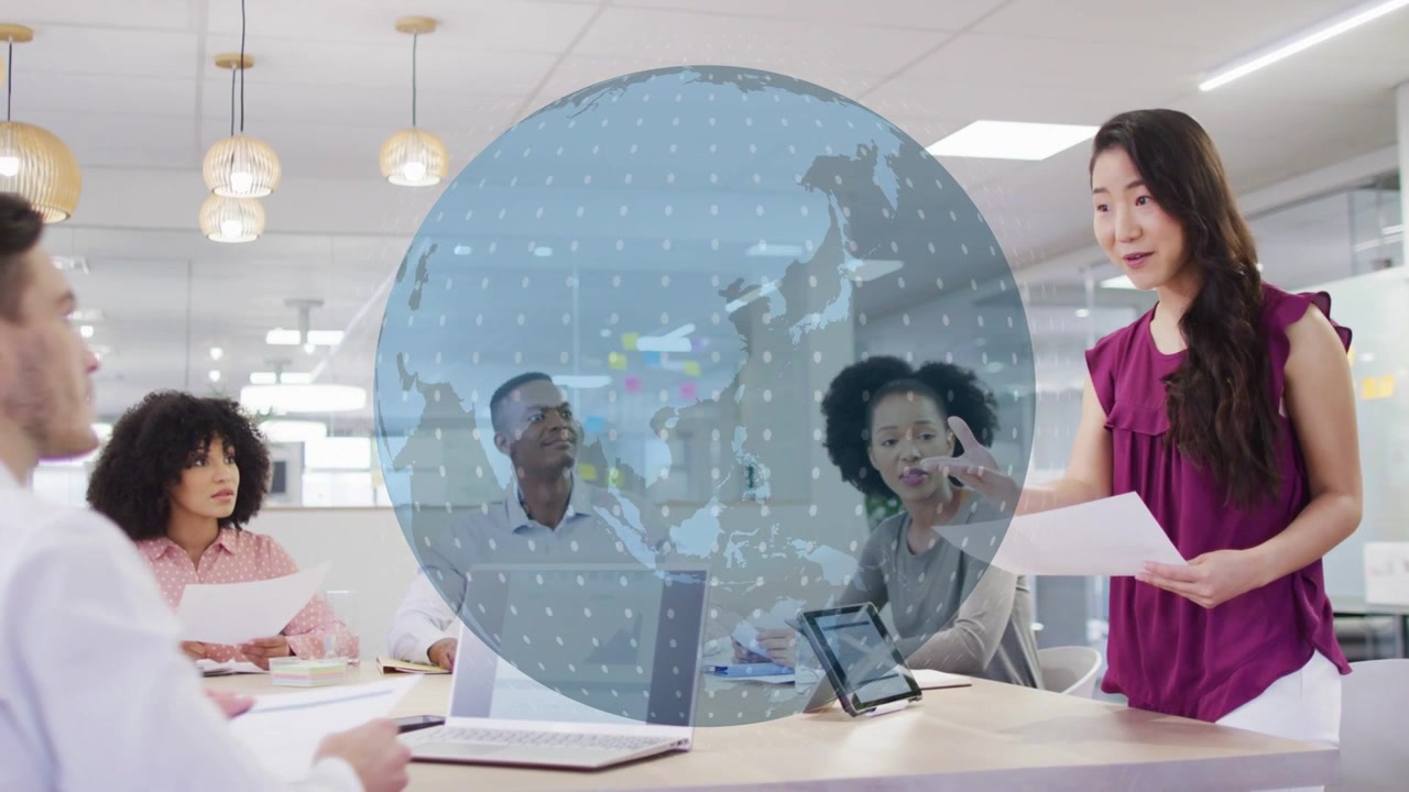 Business lead starting meeting and gesturing, causing holo globe rotating above table, team