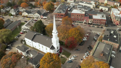 Aerial-townscape-with-white-church,-beautiful-bell-tower-and-clocks