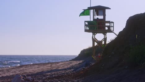 Empty-beach-near-a-lifeguard-tower-on-the-background