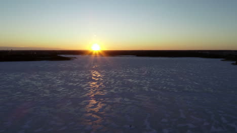 aerial video of the sunset over an icey sea landscape