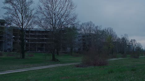 abandoned hospital façade looms over zagreb's greenery, croatia