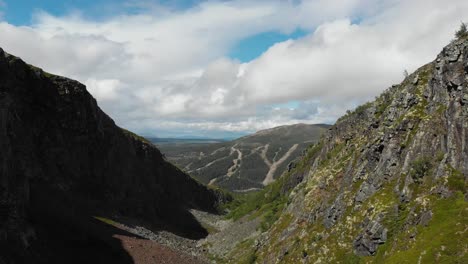 Aerial-fly-forward-shot-in-the-middle-of-Dromskåran-rocky-valley,-in-Bastudalen-Nature-Reserve,-Jämtland,-Sweden