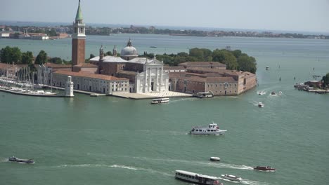 Static-shot-of-boats-over-blue-water-on-the-ocean-of-Venice-island-in-Italy