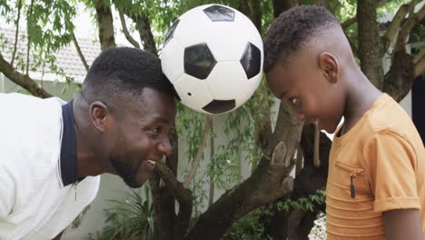 Afroamerikanischer-Vater-Und-Sohn-Genießen-Einen-Spielerischen-Moment-Im-Freien-Mit-Einem-Fußball