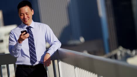 ethnic businessman using wireless app technology on rooftop