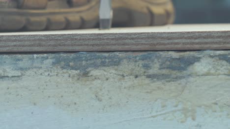 plywood edge close up securing using brass screw