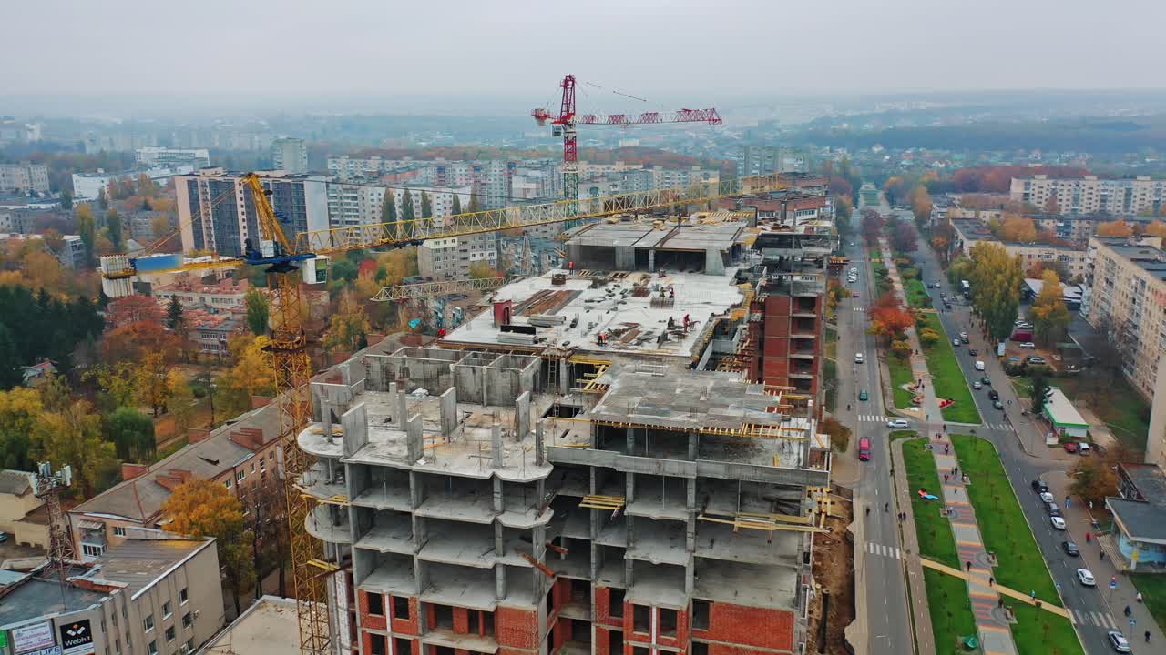 Construction site with cranes. Aerial shot of the skyscraper building in the process of construction