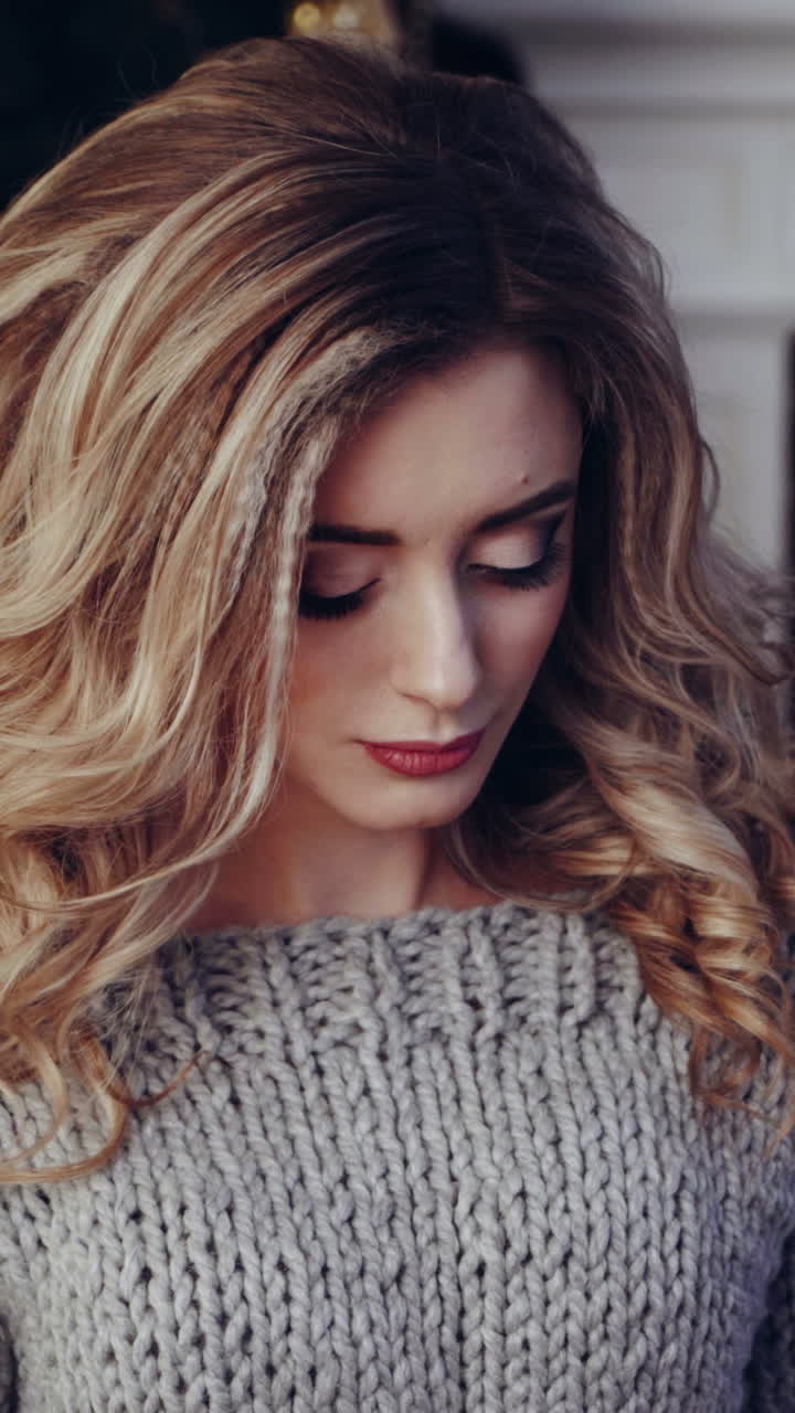 Woman opening gift boxes. Young woman with presents in New Year interior in the living room Vertical video