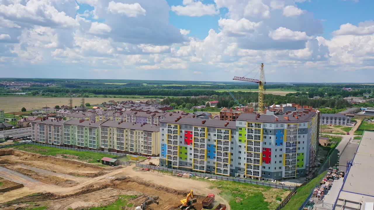 Modern district on the outskirts of a city. New multi storey buildings on the construction site. Building new residential complex. View from the air.