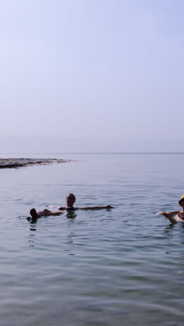 people floating in the dead sea