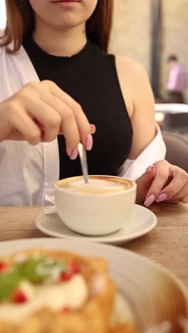 woman enjoying coffee and dessert in a cafe