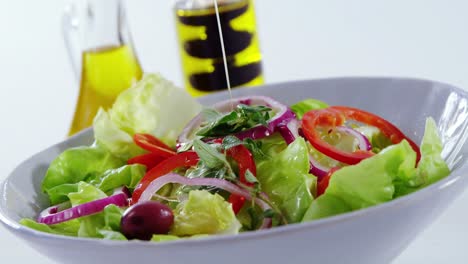 oil being poured in salad