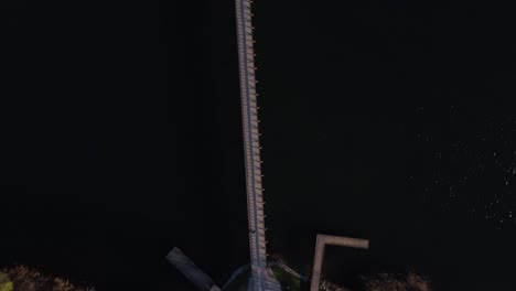aerial shot of bridge connecting two islands in the lake