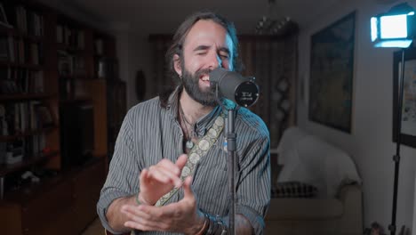 man singing into a microphone in a living room