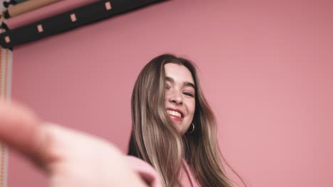 cheerful young woman standing with stretched hand
