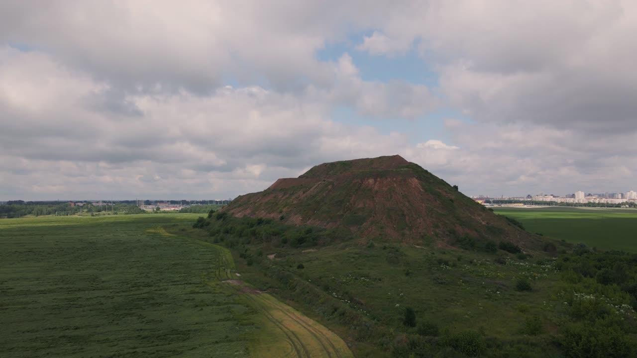 Household waste landfill. Closed for processing. Environment protection. Close-up shot. Aerial videography.