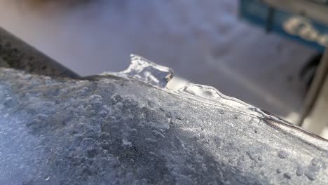 crystalline frozen ice on window ledge during snowfall winter